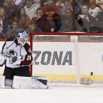 Colorado Avalanche's Reto Berra, of Switzerland, gives up a goal to Arizona Coyotes' Tobias Rieder, of Germany, Berra's third goal allowed during the first period of an NHL hockey game Tuesday, Nov. 25, 2014, in Glendale, Ariz. Berra was pulled from the game after giving up the goal. (AP Photo/Ross D. Franklin)