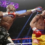 Floyd Mayweather Jr., left, hits Manny Pacquiao, from the Philippines, during their welterweight title fight on Saturday, May 2, 2015 in Las Vegas. (AP Photo/John Locher)