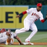 Arizona Diamondbacks' Paul Goldschmidt, left, dives back to second base, as Los Angeles Angels shortstop Erick Aybar catches the ball on a pick-off attempt during the first inning of a baseball game in Anaheim, Calif., Monday, June 15, 2015. (AP Photo/Alex Gallardo)