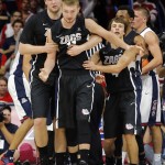 Gonzaga center Przemek Karnowski, left, and Kevin Pangos (4), right, hold back Domantas Sabonis (11) after confrontation during the second half of an NCAA college basketball game against Arizona, Saturday, Dec. 6, 2014, in Tucson, Ariz. (AP Photo/Rick Scuteri)