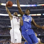 Connecticut guard Ryan Boatright, left, drives to the basket past Kentucky forward Alex Poythress during the first half of the NCAA Final Four tournament college basketball championship game Monday, April 7, 2014, in Arlington, Texas. (AP Photo/David J. Phillip)