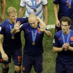  Netherlands' Arjen Robben, center, Dirk Kuyt, left, and Daryl Janmaat, right, cheer fans as they leave the pitch after the World Cup third-place soccer match between Brazil and the Netherlands at the Estadio Nacional in Brasilia, Brazil, Saturday, July 12, 2014. Robin van Persie and Daley Blind scored early goals to help give the Netherlands a 3-0 win over host Brazil in the third-place match at the World Cup on Saturday.(AP Photo/Themba Hadebe)
