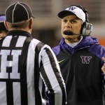 Washington coach Chris Petersen talks with an official during the first half of the Cactus Bowl NCAA college football game against Oklahoma State, Friday, Jan. 2, 2015, in Tempe, Ariz. (AP Photo/Rick Scuteri)
