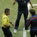 United States' head coach Juergen Klinsmann argues with the fourth official Norbert Hauata during the World Cup round of 16 soccer match between Belgium and the USA at the Arena Fonte Nova in Salvador, Brazil, Tuesday, July 1, 2014. (AP Photo/Themba Hadebe)