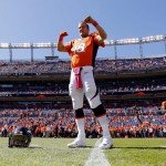 Denver Broncos quarterback Peyton Manning (18) stretches prior to an NFL football game against the Arizona Cardinals, Sunday, Oct. 5, 2014, in Denver. (AP Photo/Jack Dempsey)