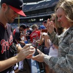  Atlanta Braves pitcher Alex Wood (40) signs a baseball for Major Patricia Hood, of the Georgia Air National Guards 116th Medical Group, before a baseball game against the Boston Red Sox on Monday, May 26, 2014, in Atlanta, Ga. (AP Photo/Butch Dill)