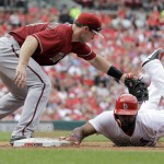 St. Louis Cardinals' Jason Heyward, right, is safe as he dives back to first ahead of the tag from Arizona Diamondbacks first baseman Paul Goldschmidt on a pick off attempt during the fourth inning of a baseball game Monday, May 25, 2015, in St. Louis. (AP Photo/Jeff Roberson)