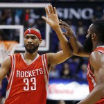 Houston Rockets' Corey Brewer (33) gets a high-five from teammate James Harden, right, after scoring against the Phoenix Suns during the second half of an NBA basketball game Tuesday, Feb. 10, 2015, in Phoenix. The Rockets won 127-118. (AP Photo/Ross D. Franklin)