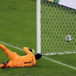 Uruguay's goalkeeper Fernando Muslera tries to stop a goal by Colombia's James Rodriguez during the World Cup round of 16 soccer match between Colombia and Uruguay at the Maracana Stadium in Rio de Janeiro, Brazil, Saturday, June 28, 2014. (AP Photo/Themba Hadebe)