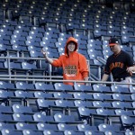 San Francisco Giants pitchers Tim Lincecum, left, and Tim Hudson, right, make their way through the stands before a baseball practice Monday, Oct. 20, 2014, in Kansas City, Mo. The Kansas City Royals will host the Giants in Game 1 of the World Series on Oct. 21. (AP Photo/David J. Phillip)