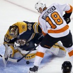 Boston Bruins goalie Tuukka Rask (40), of Finland is able to make a save against a scoring bid by Philadelphia Flyers left wing R.J. Umberger (18) in the first period of an NHL hockey game in Boston, Wednesday, Oct. 8, 2014. (AP Photo/Elise Amendola)