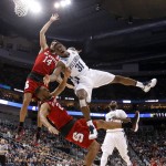 Villanova's Dylan Ennis (31) shoots as North Carolina State's Ralston Turner, bottom and Caleb Martin (14) defend during the first half of an NCAA tournament third-round college basketball game, Saturday, March 21, 2015, in Pittsburgh. (AP Photo/Gene J. Puskar)