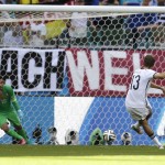Germany's Thomas Mueller (13) shoots against Portugal's goalkeeper Rui Patricio (12) to score his side's first goal during the group G World Cup soccer match between Germany and Portugal at the Arena Fonte Nova in Salvador, Brazil, Monday, June 16, 2014. (AP Photo/Natacha Pisarenko)