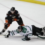 Anaheim Ducks' Corey Perry, top, shoots to score against Dallas Stars goalie Tim Thomas during the third period of Game 5 of the first-round NHL hockey Stanley Cup playoff series on Friday, April 25, 2014, in Anaheim, Calif. The Ducks won 6-2. (AP Photo/Jae C. Hong)