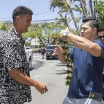 Former Oregon quarterback Marcus Mariota, left, is greeted by his friend Matt Wright, right, after arriving at the Saint Louis Alumni Clubhouse on NFL Draft Day Thursday, April 30, 2015, in Honolulu. (AP Photo/Eugene Tanner)