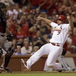 St. Louis Cardinals' Matt Holliday scores on a double by Allen Craig as Arizona Diamondbacks catcher Tuffy Gosewisch stands by during the seventh inning of a baseball game Thursday, May 22, 2014, in St. Louis. (AP Photo/Jeff Roberson)
