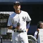  New York Yankees' Derek Jeter holds the microphone as he addresses the crowd during a pregame ceremony honoring the Yankees captain, who is retiring at the end of the season, on Derek Jeter Day at Yankee Stadium in New York, Sunday, Sept. 7, 2014. game (AP Photo/Kathy Willens)