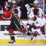 Arizona Coyotes' Craig Cunningham, right, collides with Calgary Flames' Deryk Engelland during the first period of an NHL hockey game, Tuesday, April 7, 2015 in Calgary, Alberta. (AP Photo/The Canadian Press, Larry MacDougal)