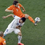 Netherlands' Daley Blind (5) challenges Chile's Charles Aranguiz (20) for the ball during the group B World Cup soccer match between the Netherlands and Chile at the Itaquerao Stadium in Sao Paulo, Brazil, Monday, June 23, 2014. (AP Photo/Thanassis Stavrakis)