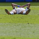 Argentina's Angel di Maria lays on the pitch after getting injured during the World Cup quarterfinal soccer match between Argentina and Belgium at the Estadio Nacional in Brasilia, Brazil, Saturday, July 5, 2014. (AP Photo/Frank Augstein)