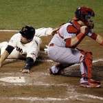 San Francisco Giants' Juan Perez, left, scores past St. Louis Cardinals catcher A.J. Pierzynski on a hit by Gregor Blanco during the sixth inning of Game 4 of the National League baseball championship series Wednesday, Oct. 15, 2014, in San Francisco. (AP Photo/Eric Risberg)