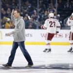 NASCAR driver Kevin Harvick waves after dropping the ceremonial first puck before the first period of an NHL hockey game between the Los Angeles Kings and Arizona Coyotes, Monday, March 16, 2015, in Los Angeles. (AP Photo/Danny Moloshok)