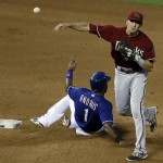 Texas Rangers' Elvis Andrus (1) slides safely into second as Arizona Diamondbacks shortstop Nick Ahmed makes the throw to first for the attempted double play in the fourth inning of an interleague baseball game Wednesday, July 8, 2015, in Arlington, Texas. Diamonbacks second baseman Cliff Pennington was issued on error on the flip to Ahmed that allowed the Rangers Rougned Odor to reach first safely. (AP Photo/Tony Gutierrez)
