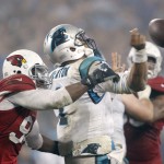 Arizona Cardinals' Sam Acho (94) knocks the ball from Carolina Panthers' Cam Newton (1) in the second half of an NFL wild card playoff football game in Charlotte, N.C., Saturday, Jan. 3, 2015. The play was ruled an incomplete pass. (AP Photo/Bob Leverone)