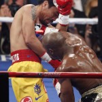 Manny Pacquiao, from the Philippines, left, gets hit by Floyd Mayweather Jr., during their welterweight title fight on Saturday, May 2, 2015 in Las Vegas. (AP Photo/Eric Jamison)