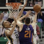Utah Jazz' Rudy Gobert, left, tries to block the shot of Phoenix Suns Alex Len during the second half of an NBA basketball game in Salt Lake City, Saturday, Nov. 1, 2014. The Jazz defeated the Suns 118-91. (AP Photo/George Frey)