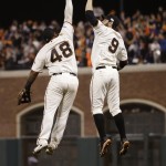 San Francisco Giants Pablo Sandoval, left, leaps up to high five Brandon Belt after defeating the Kansas City Royals 11-4 in Game 4 of baseball's World Series Saturday, Oct. 25, 2014, in San Francisco. The Giants tied the series 2-2. (AP Photo/Matt Slocum)