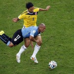 Colombia's Abel Aguilar, top, and Uruguay's Egidio Arevalo Rios challenge for the ball during the World Cup round of 16 soccer match between Colombia and Uruguay at the Maracana Stadium in Rio de Janeiro, Brazil, Saturday, June 28, 2014. (AP Photo/Fabrizio Bensch, pool)