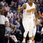 Phoenix Suns' P.J. Tucker celebrates after sinking a shot against the Miami Heat during the first half of an NBA basketball game Tuesday, Dec. 9, 2014, in Phoenix. (AP Photo/Ross D. Franklin)