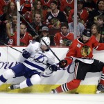 Tampa Bay Lightning's Anton Stralman, of Sweden, falls as he chases after a loose puck along the boards with Chicago Blackhawks' Antoine Vermette, right, during the second period in Game 6 of the NHL hockey Stanley Cup Final series on Monday, June 15, 2015, in Chicago. (AP Photo/Nam Y. Huh)