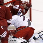 Arizona Coyotes' Oliver Ekman-Larsson (23), of Sweden, ends up in the net after scoring a goal against Columbus Blue Jackets' Sergei Bobrovsky, right, of Russia, during the second period of an NHL hockey game Saturday, Jan. 3, 2015, in Glendale, Ariz. (AP Photo/Ross D. Franklin)