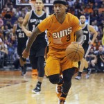 Phoenix Suns guard Isaiah Thomas (3) drives on the San Antonio Spurs defense in the second quarter during an NBA basketball game, Friday, Oct. 31, 2014, in Phoenix. (AP Photo/Rick Scuteri)