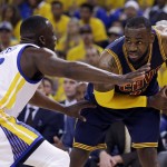 Cleveland Cavaliers forward LeBron James, right, is guarded by Golden State Warriors forward Draymond Green during the first half of Game 5 of basketball's NBA Finals in Oakland, Calif., Sunday, June 14, 2015. (AP Photo/Ben Margot)
