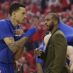 Los Angeles Clippers' Chris Paul, right, talks with teammate Matt Barnes, left, prior to Game 1 in a second-round NBA basketball playoff series against the Houston Rockets, Monday, May 4, 2015, in Houston. Chris Paul is out for game 1 with a strained left hamstring. (AP Photo/David J. Phillip)