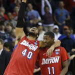Dayton's Devon Scott (40) and Scoochie Smith (11) celebrate after the second half in a regional semifinal game against Stanford at the NCAA college basketball tournament, Thursday, March 27, 2014, in Memphis, Tenn. Dayton won 82-72. (AP Photo/John Bazemore)