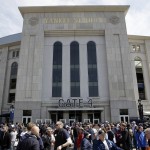 A line to pass through metal detectors winds around the front of Yankee Stadium before the opening day baseball game between the Toronto Blue Jays and the New York Yankees, Monday, April 6, 2015 in New York. (AP Photo/Seth Wenig)