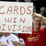 A fan holds up a sign before a baseball game between the Arizona Diamondbacks and the St. Louis Cardinals, Sunday, Sept. 28, 2014, in Phoenix. The St. Louis Cardinals won the National League Central Division with a Pittsburgh Pirates loss earlier in the day. (AP Photo/Rick Scuteri)