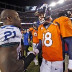 Denver Broncos quarterback Peyton Manning (18) greets Indianapolis Colts cornerback Vontae Davis (21) after an NFL divisional playoff football game, Sunday, Jan. 11, 2015, in Denver. The Colts won 24-13 to advance to the AFC Championship game against the New England Patriots. (AP Photo/Jack Dempsey)
