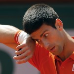 Serbia's Novak Djokovic wipes his forehead as he plays Switzerland's Stan Wawrinka during their final match of the French Open tennis tournament at the Roland Garros stadium, Sunday, June 7, 2015 in Paris. (AP Photo/Francois Mori)
