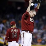 Arizona Diamondbacks pitcher Trevor Cahill wipes his head during the fourth inning of a baseball game against the Detroit Tigers, Wednesday, July 23, 2014, in Phoenix. (AP Photo/Matt York)
