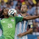  Nigeria's Michael Uchebo, left, and Argentina's Javier Mascherano challenge for the ball during the group F World Cup soccer match between Nigeria and Argentina at the Estadio Beira-Rio in Porto Alegre, Brazil, Wednesday, June 25, 2014. (AP Photo/Fernando Vergara)