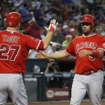 Los Angeles Angels' Mike Trout (27) and Albert Pujols celebrate after both scoring runs against the Arizona Diamondbacks during the sixth inning of a baseball game Thursday, June 18, 2015, in Phoenix. (AP Photo/Ross D. Franklin)