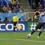 Uruguay's Luis Suarez scores his side's second goal during the group D World Cup soccer match between Uruguay and England at the Itaquerao Stadium in Sao Paulo, Brazil, Thursday, June 19, 2014. (AP Photo/Matt Dunham)