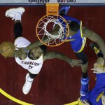 Cleveland Cavaliers guard J.R. Smith (5) has his shot blocked Golden State Warriors center Festus Ezeli (31) during the first half of Game 6 of basketball's NBA Finals in Cleveland, Tuesday, June 16, 2015. (AP Photo/Tony Dejak)
