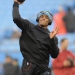 Carolina Panthers' Cam Newton warms up before an NFL wild-card playoff football game against the Arizona Cardinals in Charlotte, N.C., Saturday, Jan. 3, 2015. (AP Photo/Mike McCarn)