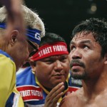 Manny Pacquiao, from the Philippines, right, listens to his trainer Freddie Roach, left, during their welterweight title fight on Saturday, May 2, 2015 in Las Vegas. (AP Photo/John Locher)